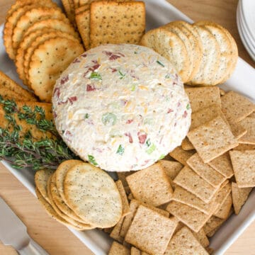 Close up of dried beef cheese ball next to crackers