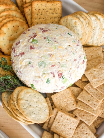 Close up of dried beef cheese ball next to crackers