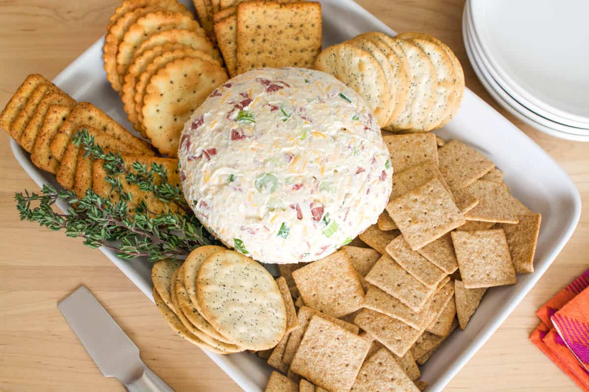 Dried Beef Cheeseball on a serving tray with crackers for a party.