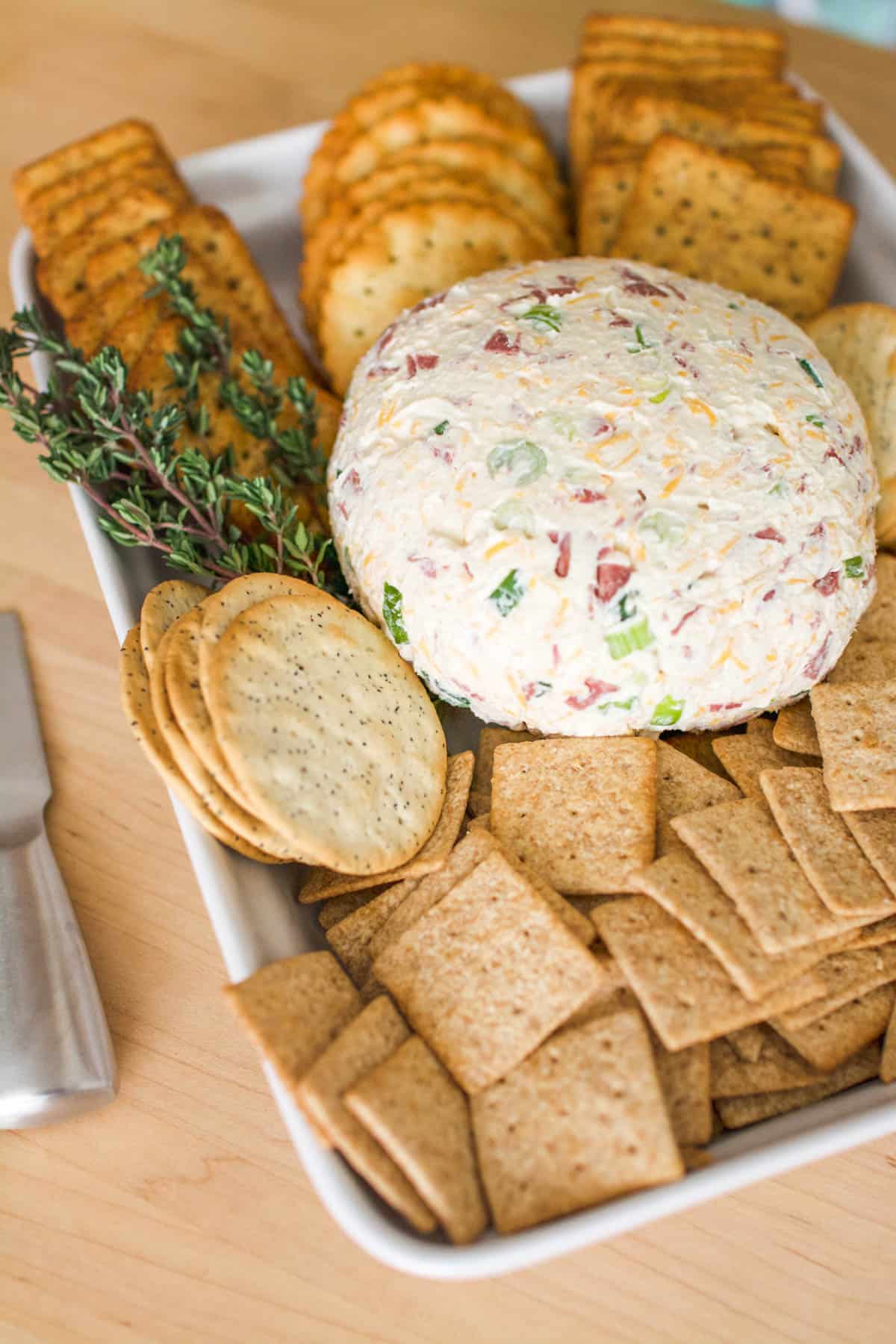 Dried Beef Cream Cheese Ball on a platter with a variety of crackers.