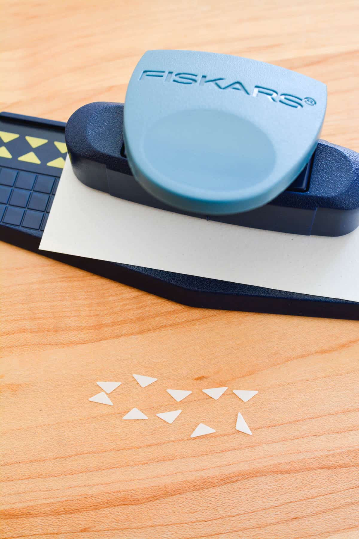 A decorative hole puncher punching triangle shapes