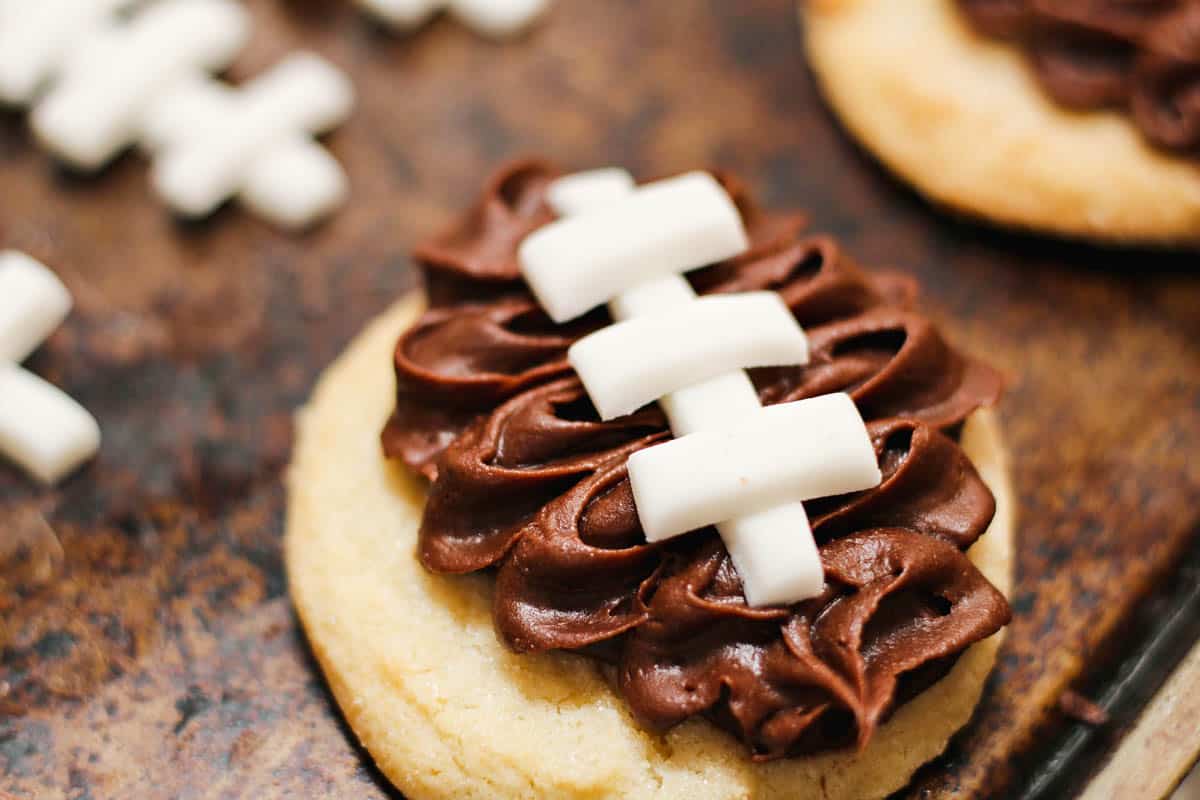 Close up of frosted football cookies with fondant laces.