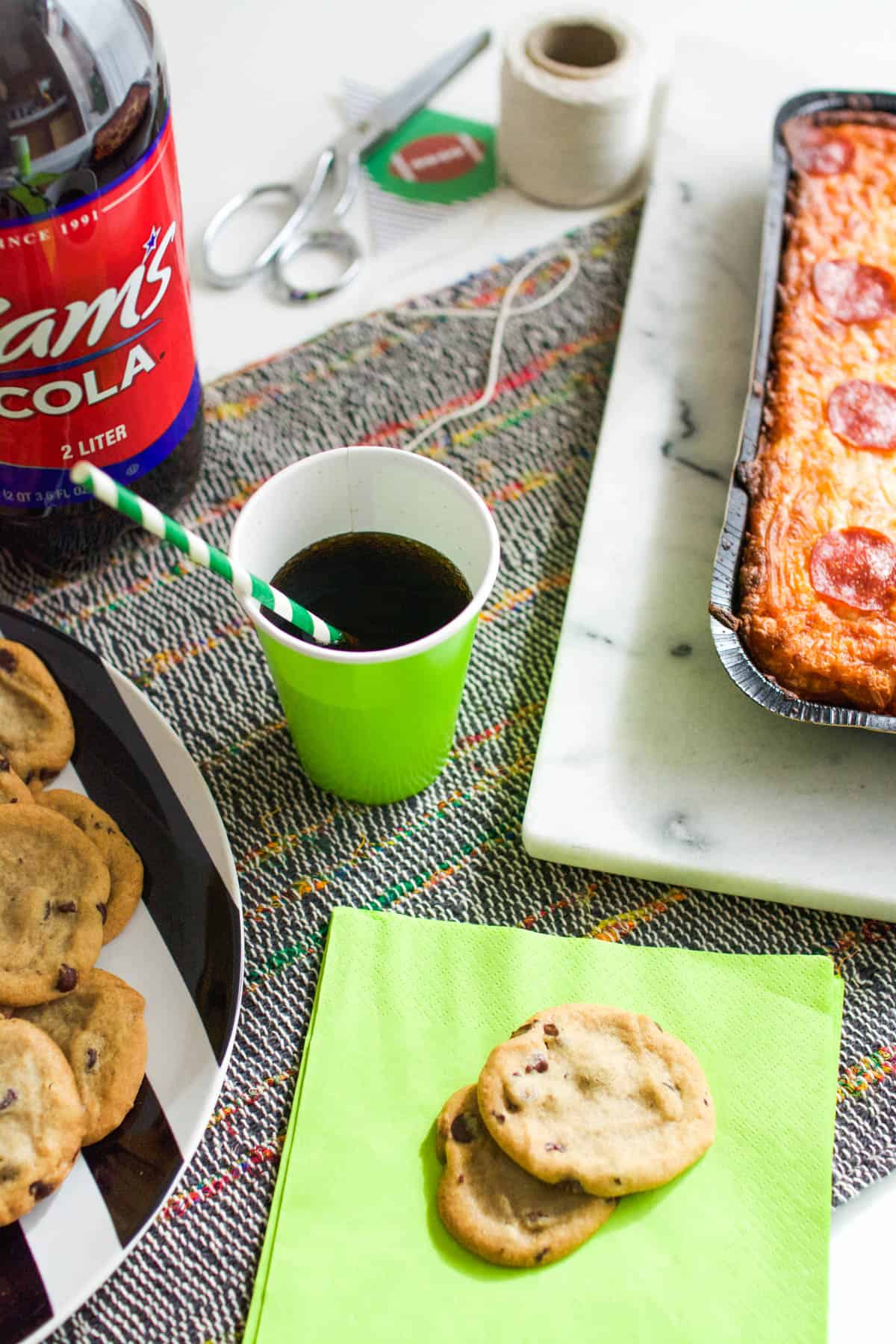 Party food on a table next to some craft supplies.