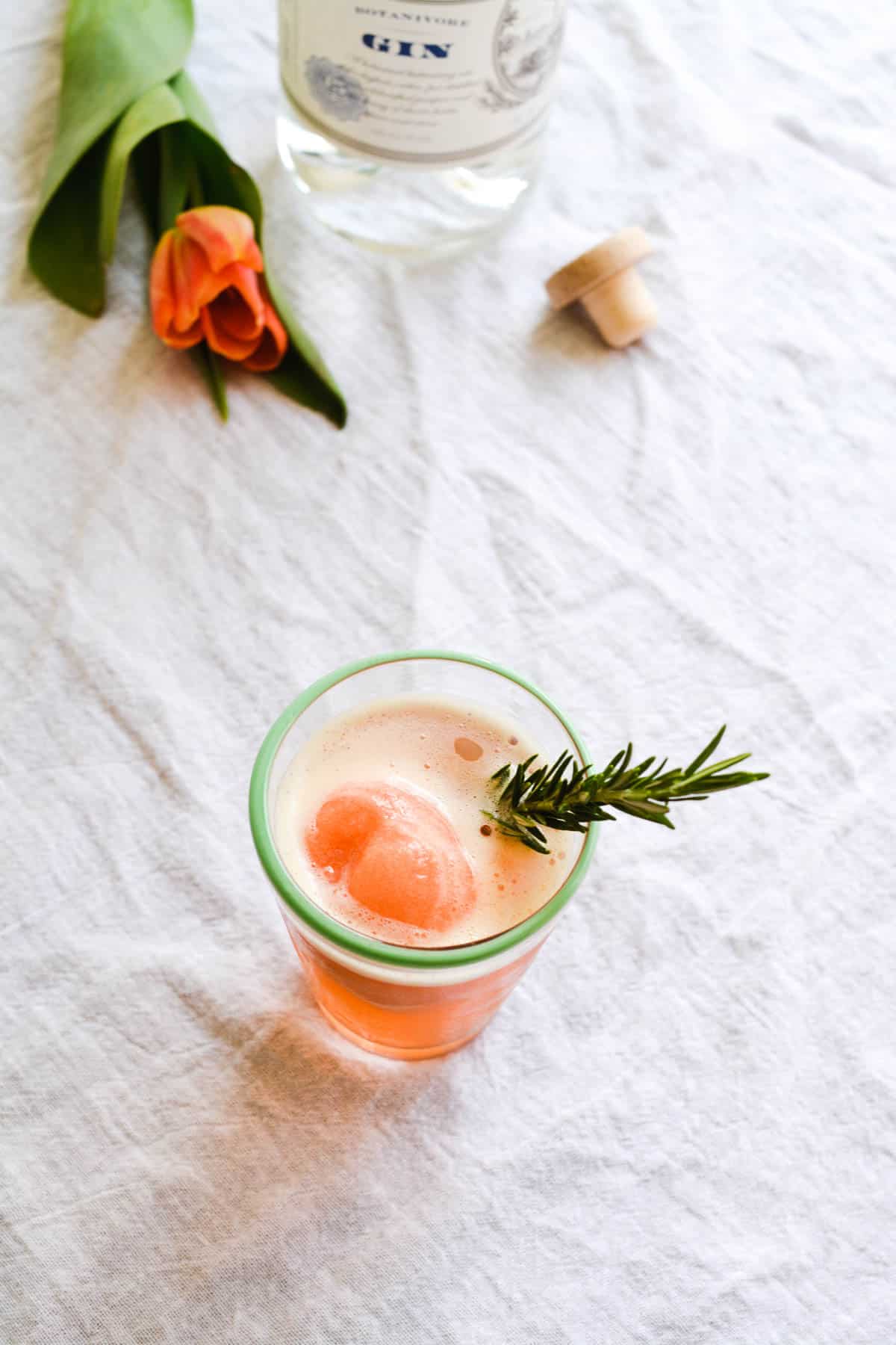 A cocktail cup on a table with a boozy float on it