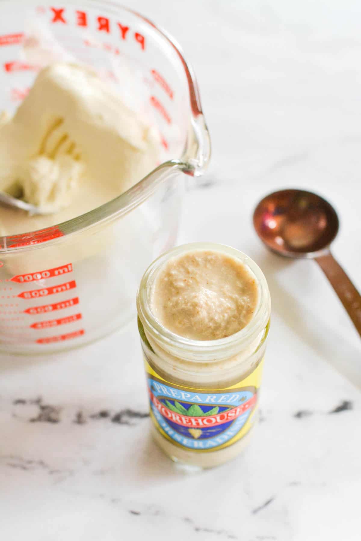 Jar of horseradish on a counter.