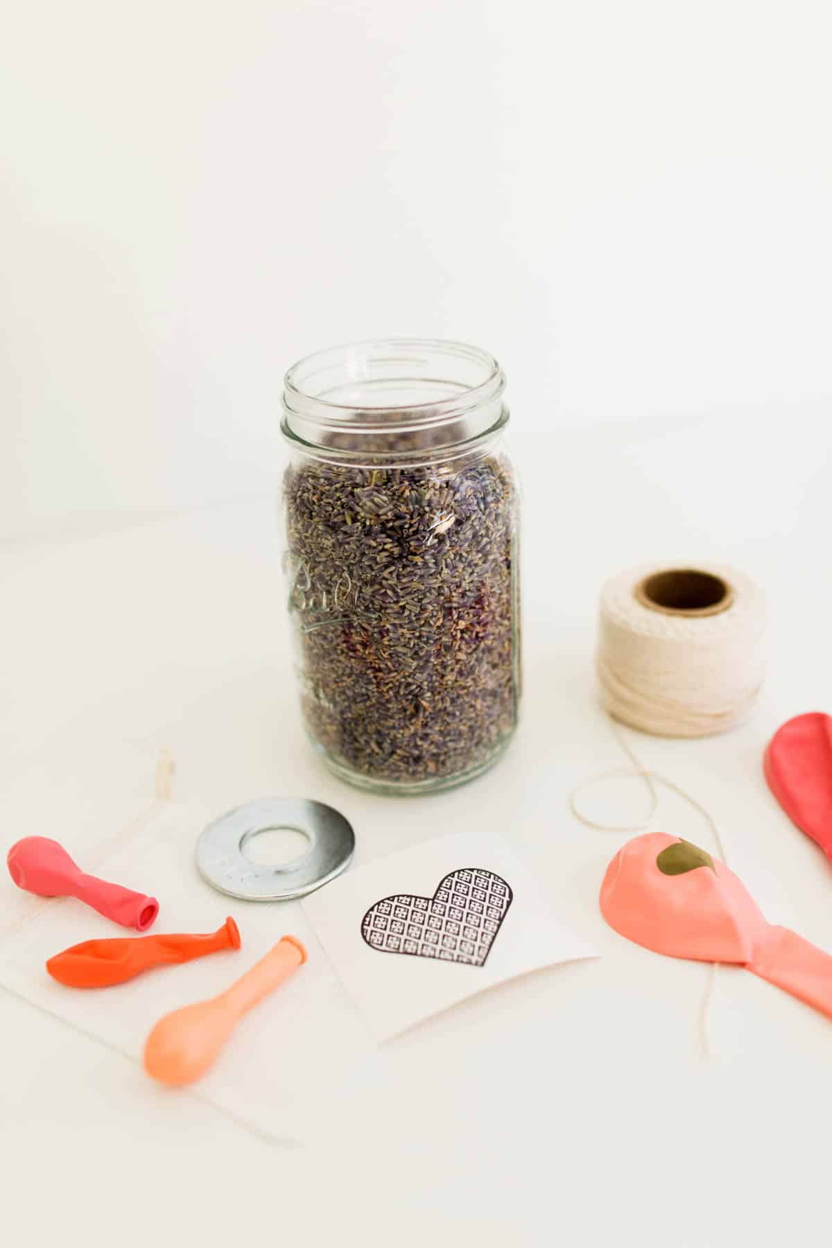 Supplies to make a lavender sachet and Valentine balloon bouquet laid out on a table.