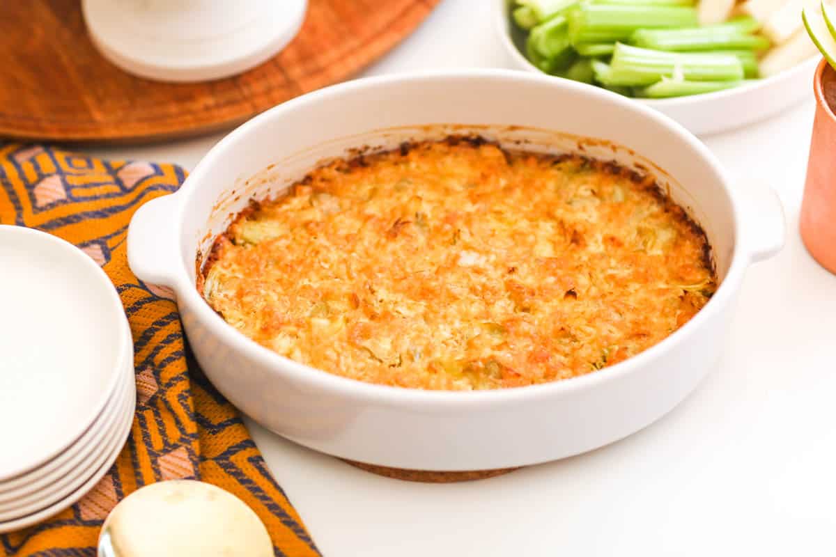 Baked artichoke dip in a dish on a table.