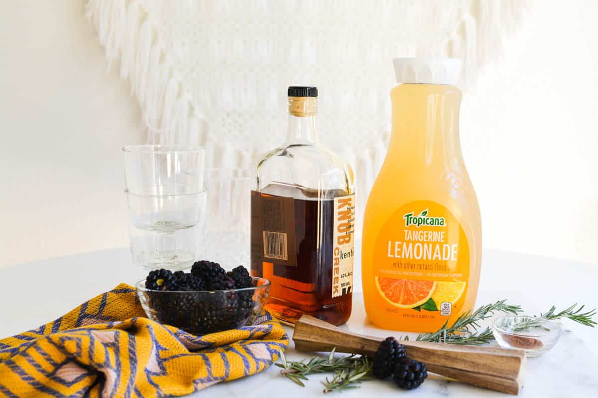 Ingredients to make a blackberry whiskey lemonade cocktail