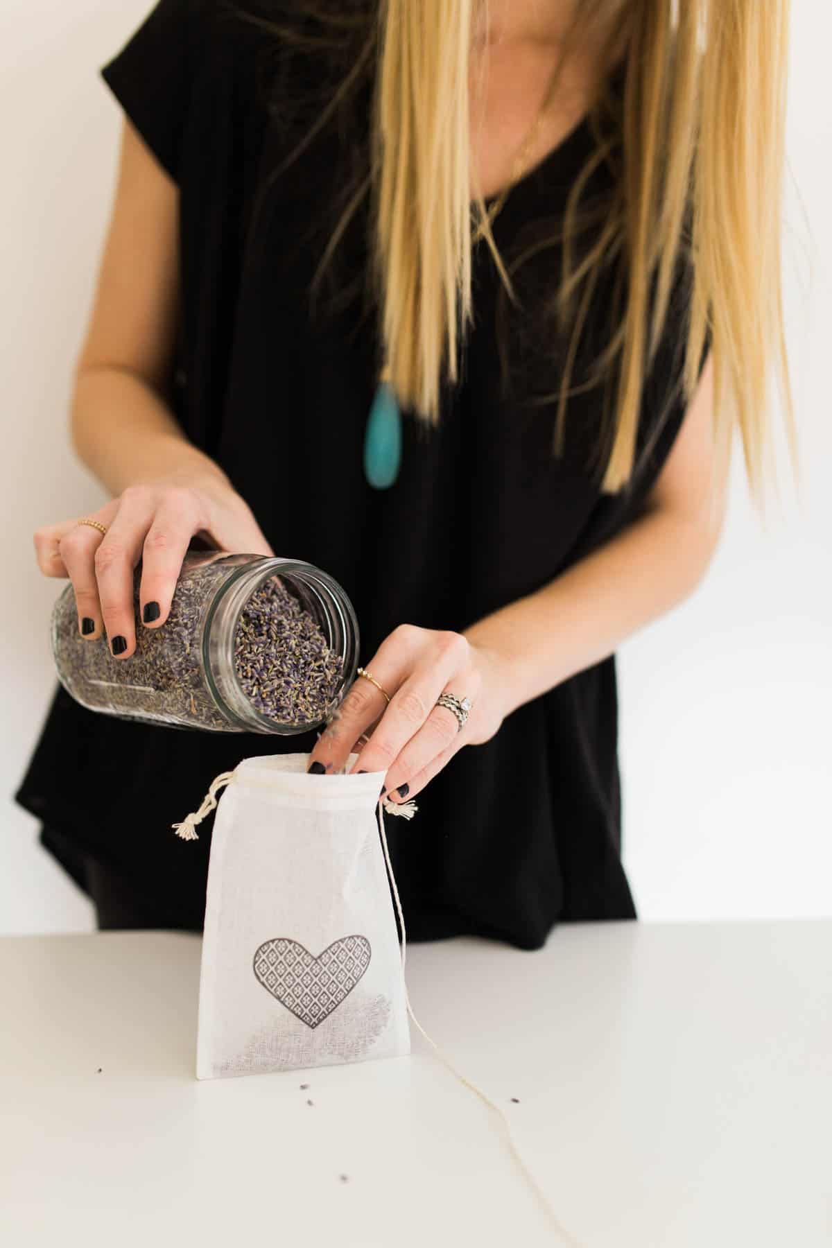 Adding dried lavender to a muslin bag for a homemade balloon weight.