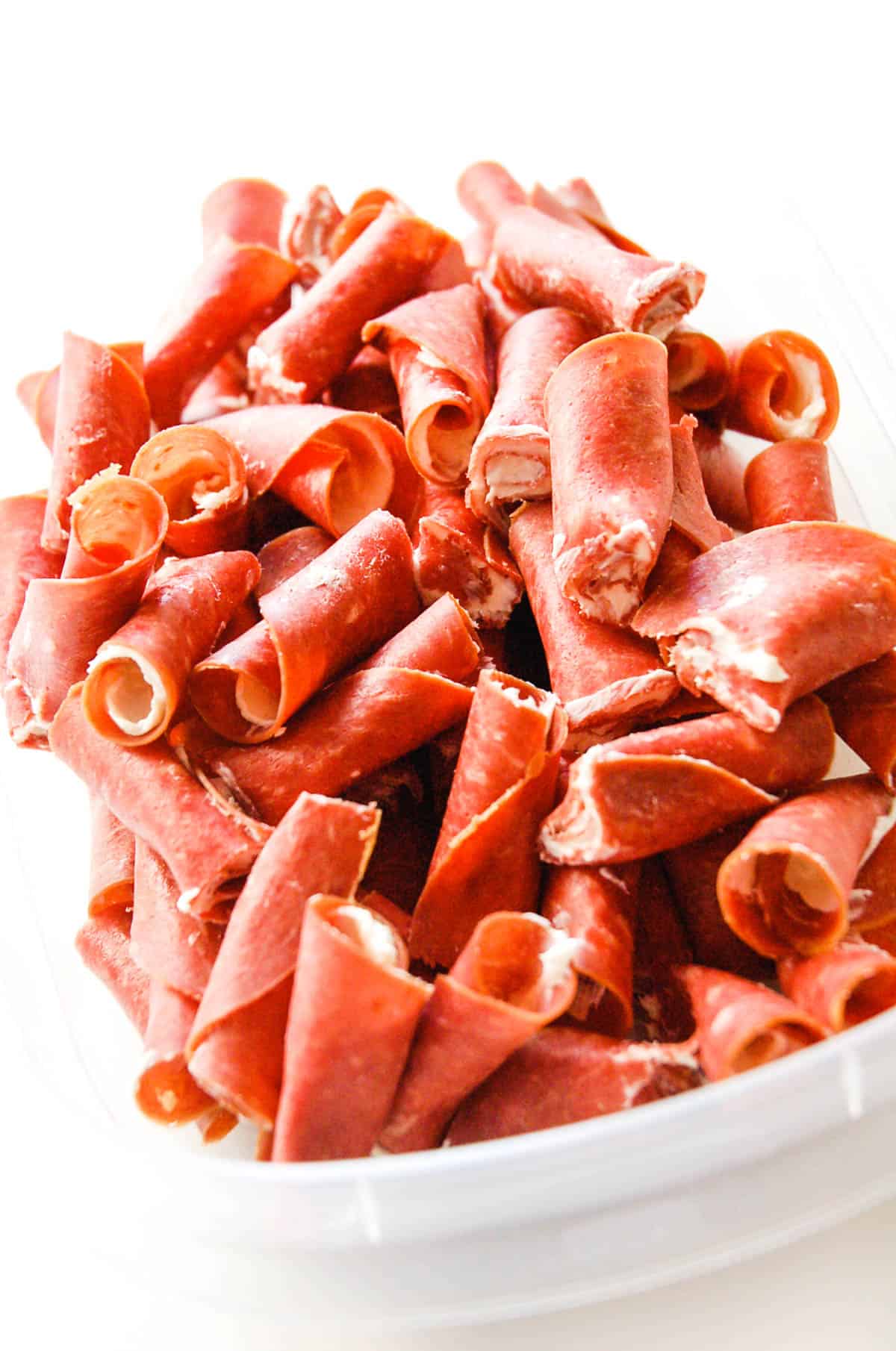 Close up of a container of easy dried beef snacks for a football party.