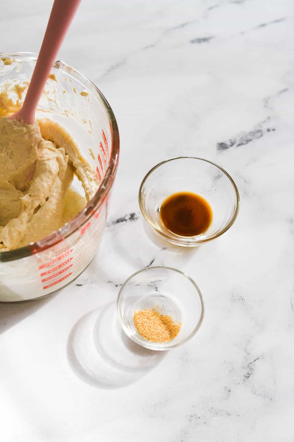 Small bowls of spices next to a mixing bowl for an easy appetizer recipe.