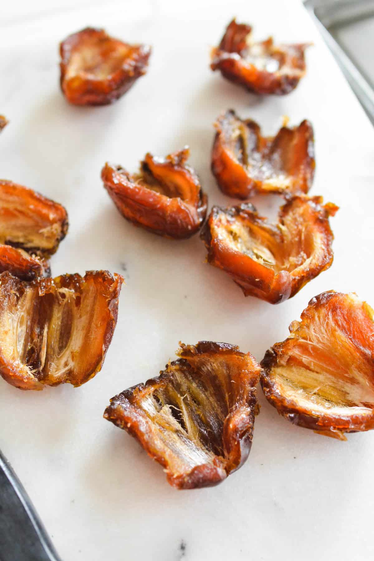 Dates split open on a cutting board