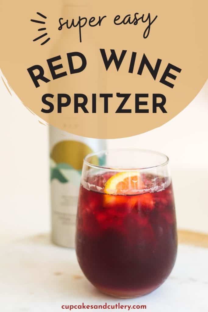 Red wine spritzer in a tumbler garnished with a lemon wedge.