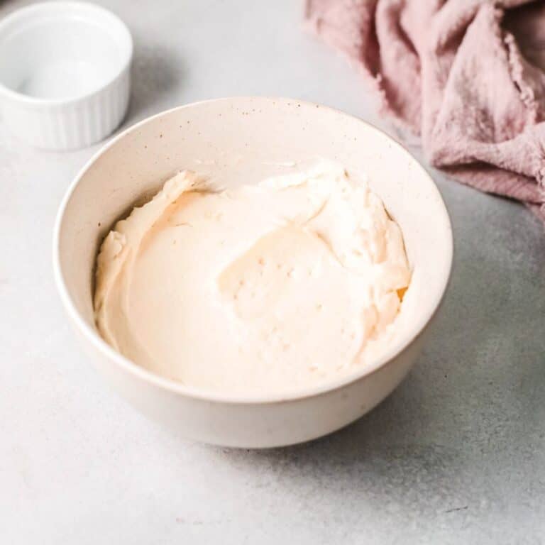 Close up image of russian butter cream frosting in a white bowl.
