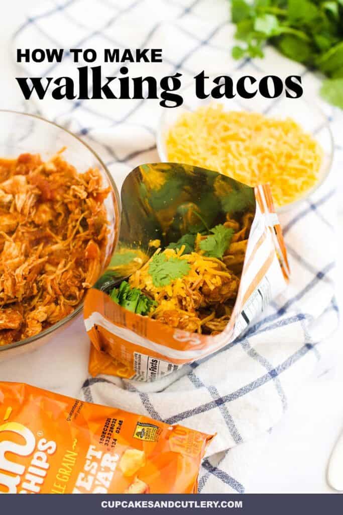 Open bag of chips topped with salsa shredded chicken for Walking Tacos.