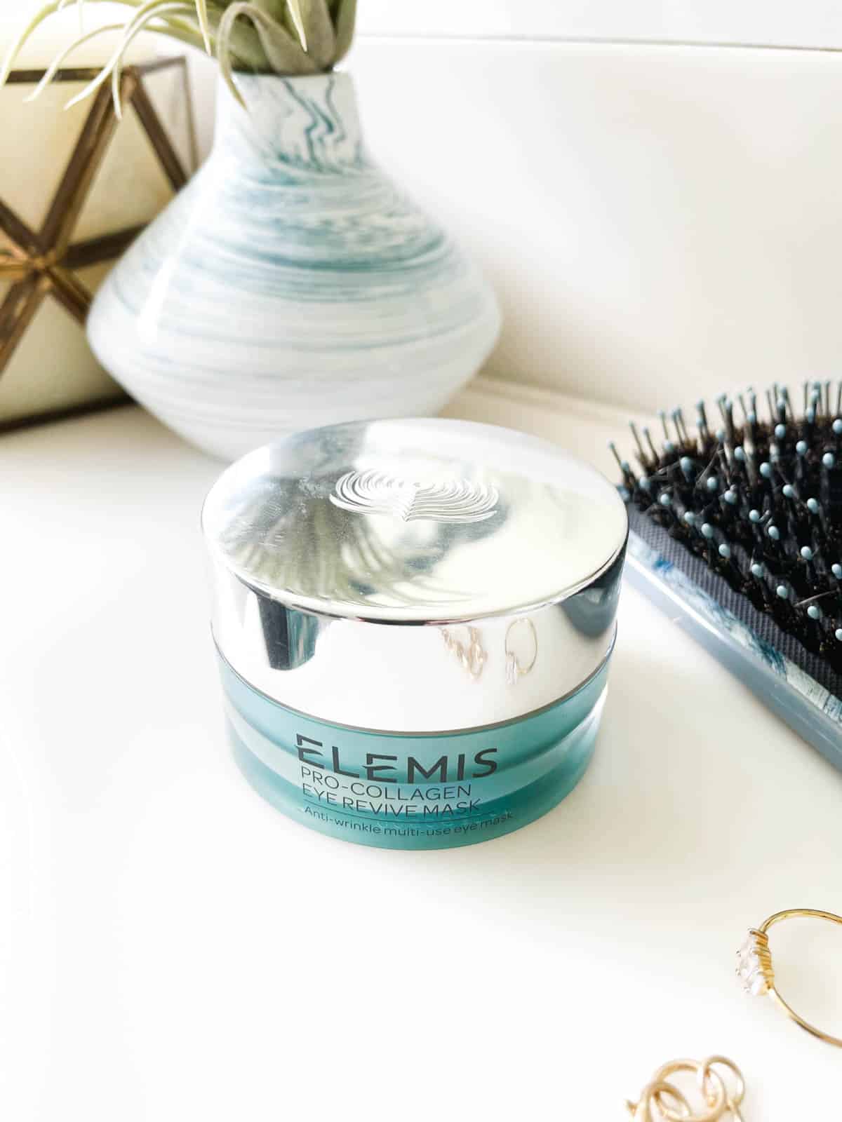 Close up of a jar of Elemis Pro-Collagen Eye Revive Mask on a counter.