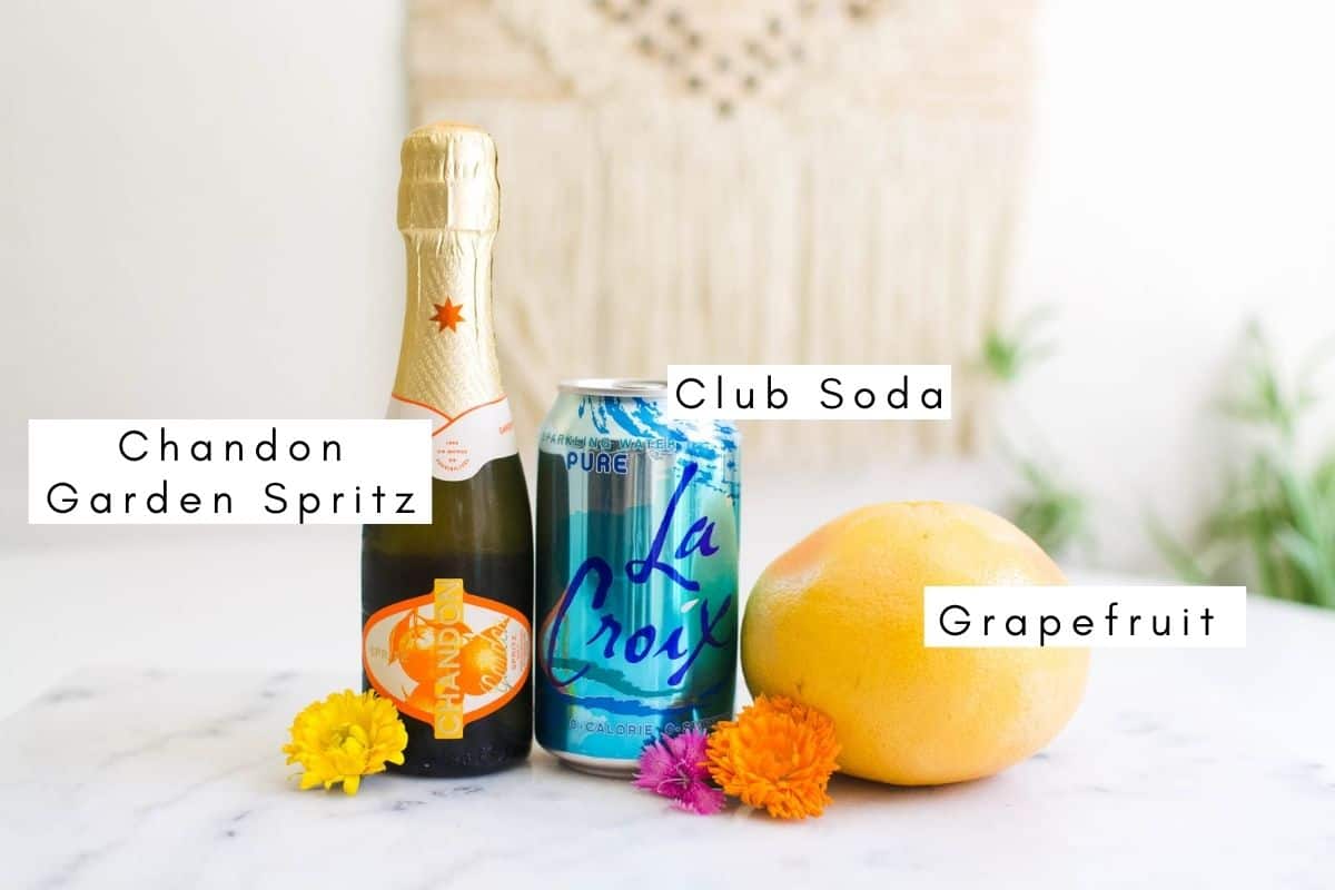 Labeled ingredients to make a sparkling white wine grapefruit spritzer.