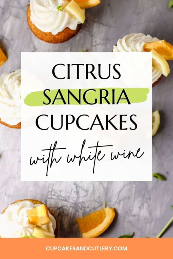 Top down image of sangria cupcakes decorated with wine infused frosting and orange slices on a grey background.