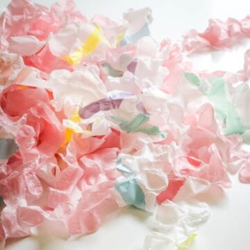 Close up of ruffled plastic streamers that are homemade on a table.