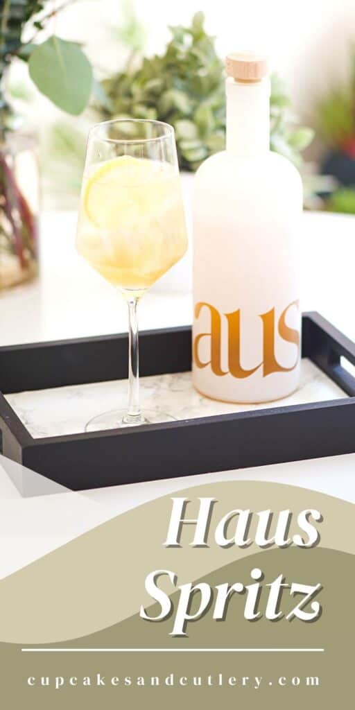 pinnable image with glass of haus spritzer on a serving tray