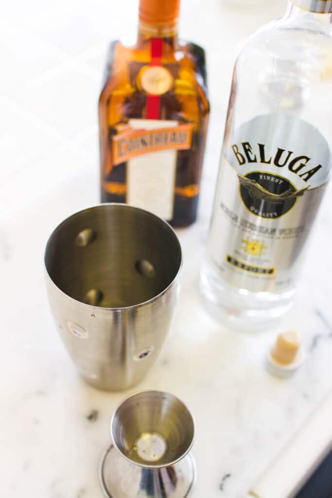 Overhead view of a cocktail shaker and bottles of liquor.