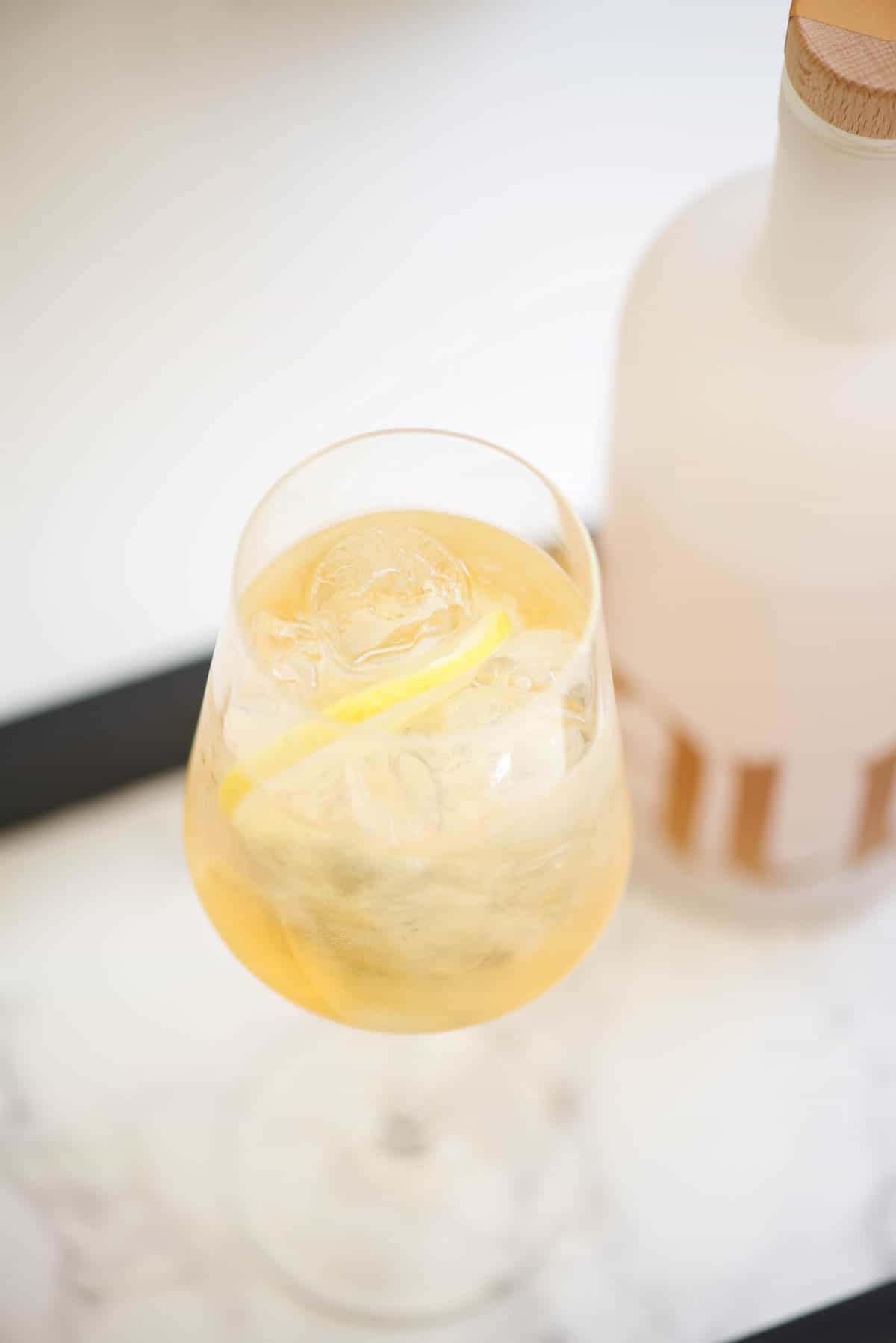 Wine glass of Haus Spritzer on a serving tray.