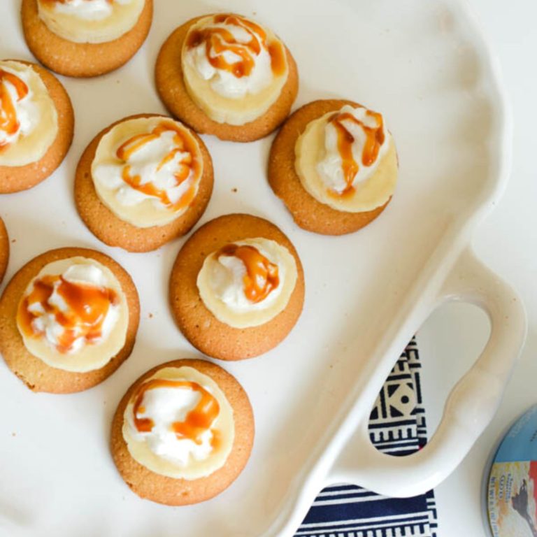 Close up of banana bites on wafer cookies with whipped cream and caramel.