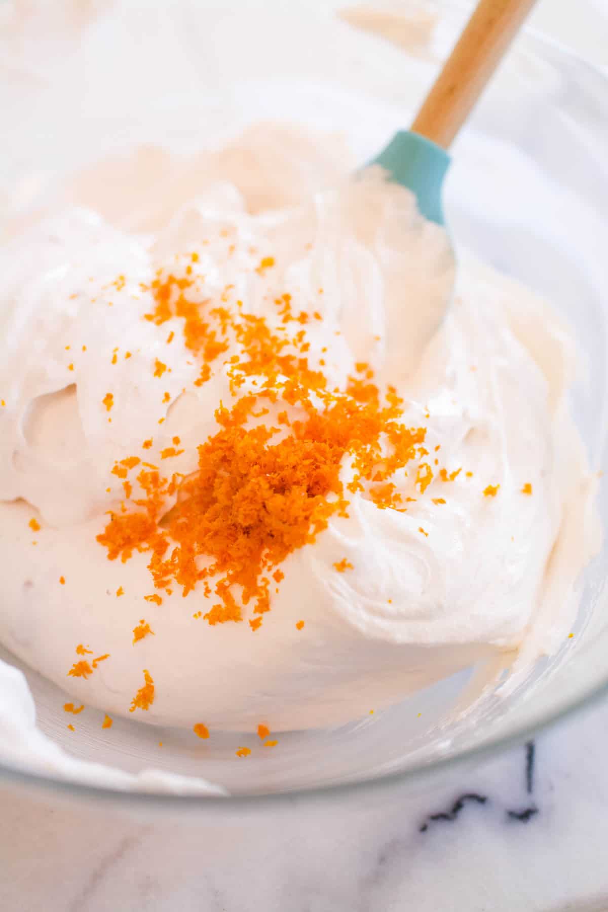 Orange zest added to a strawberry yogurt mixture for a frozen pie recipe.