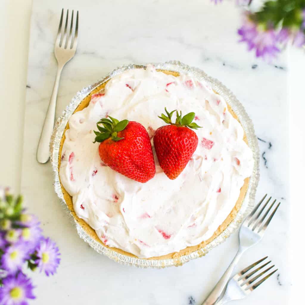 Close up of Frozen Strawberry Pie recipe with fresh strawberries on top.