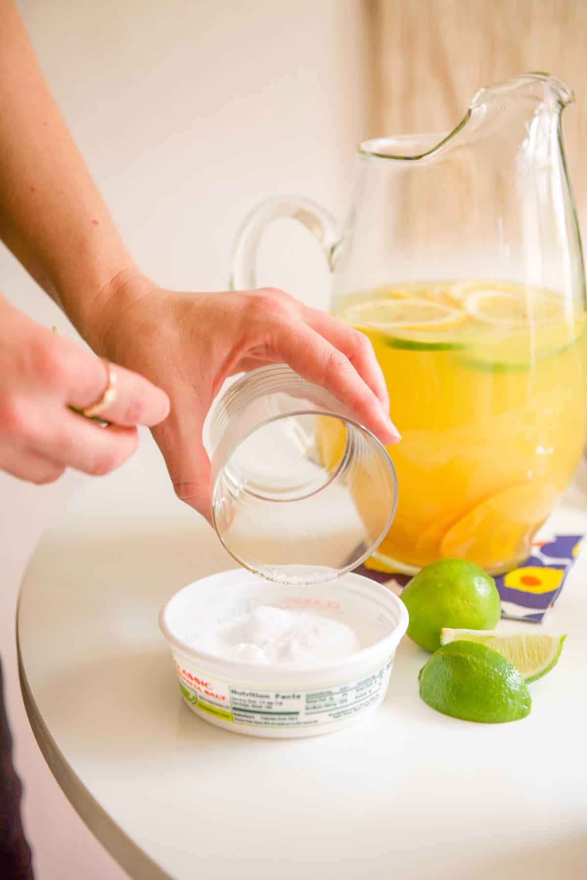 Adding salt to the rim of the cocktail glass. 