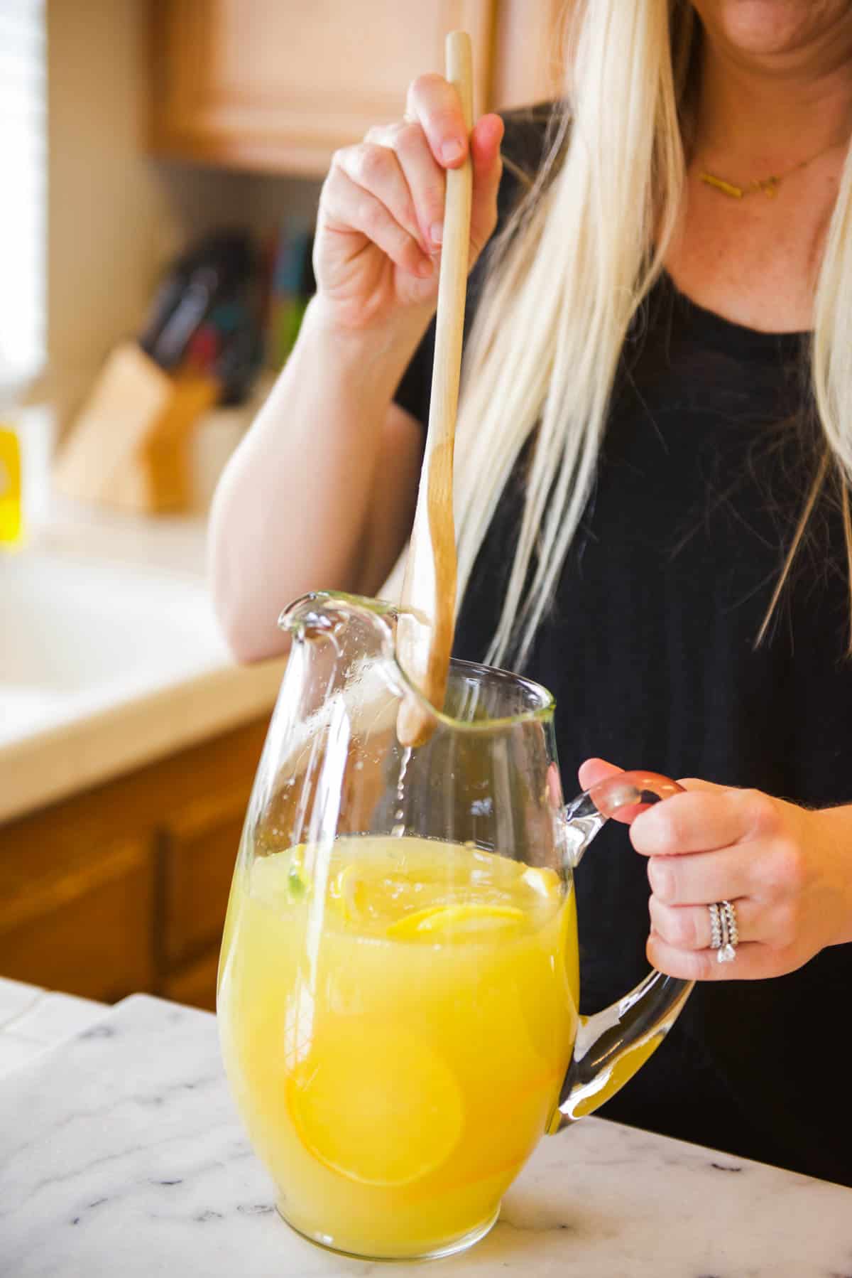 Stirring the margarita to store and chill in the fridge. 