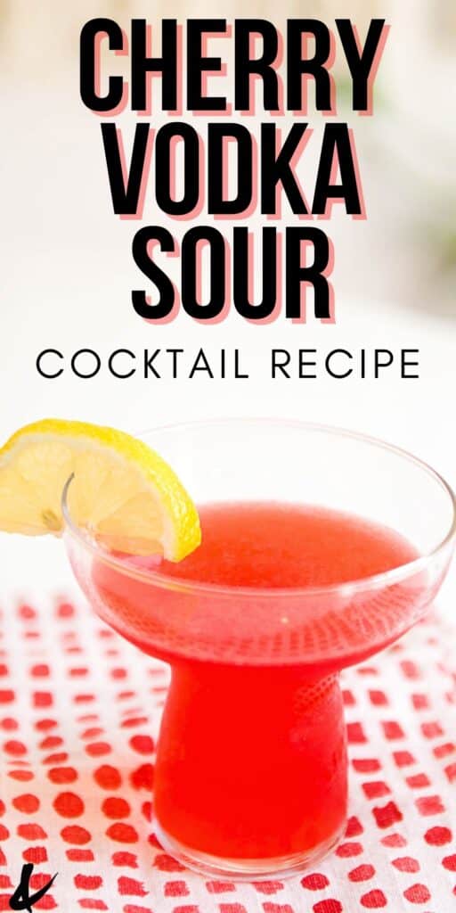 Bright pink cherry vodka sour cocktail with lemon slice garnish.