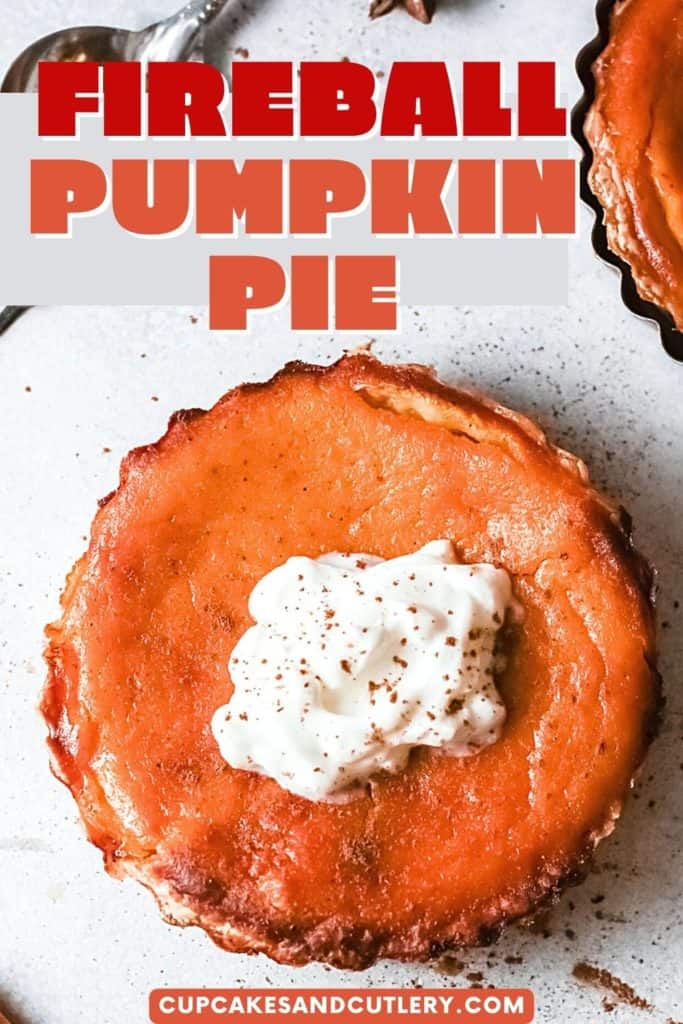 Close up of a mini pumpkin pie topped with whipped cream.