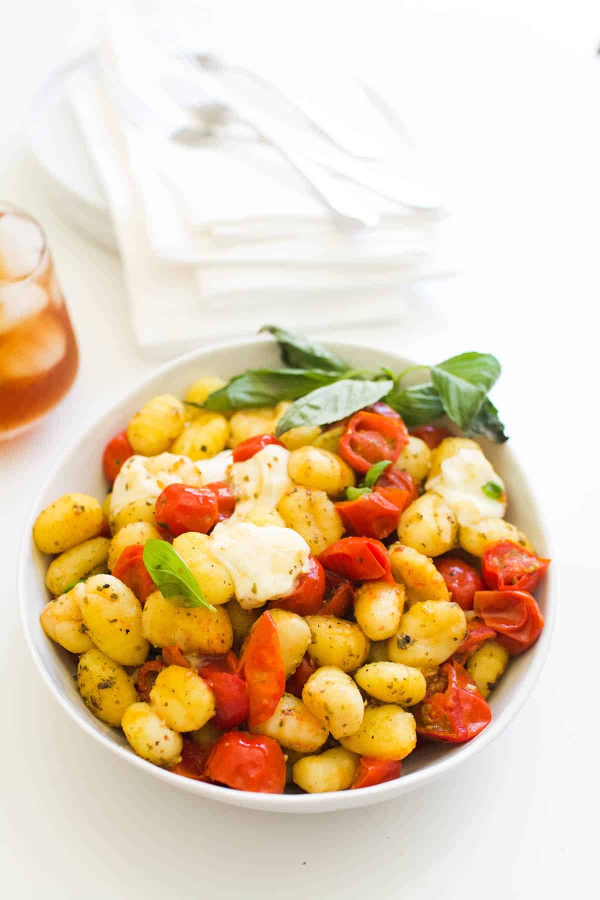 A bowl of caprese gnocchi bake for a dinner side dish.