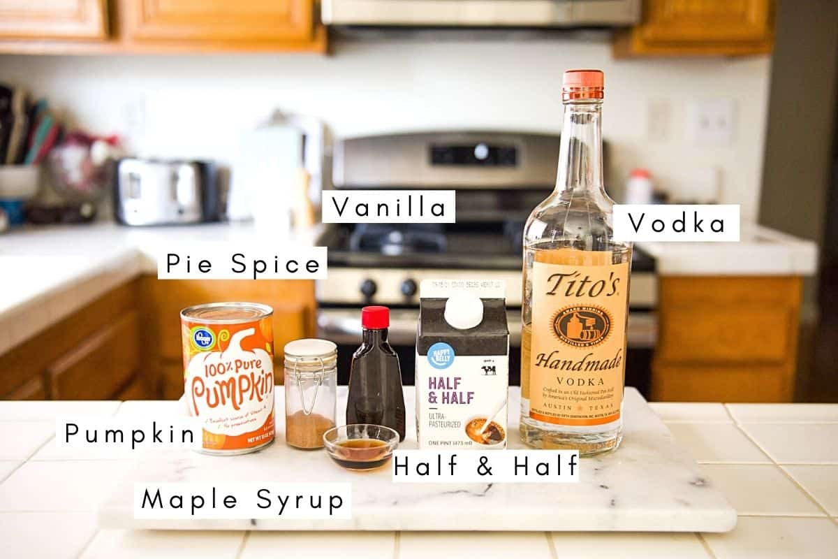 Labeled ingredients to make a pumpkin martini recipe on a counter.