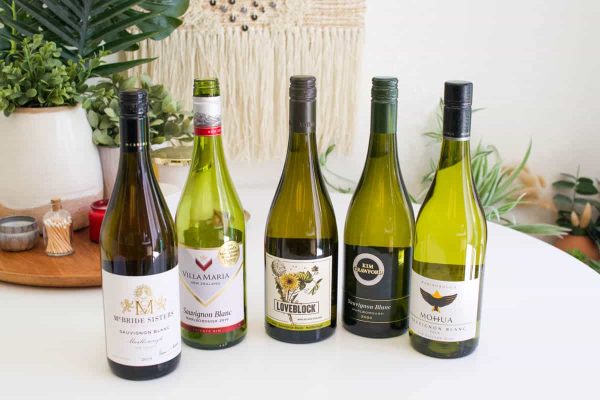5 bottles of Sauvignon Blanc from New Zealand on a table.