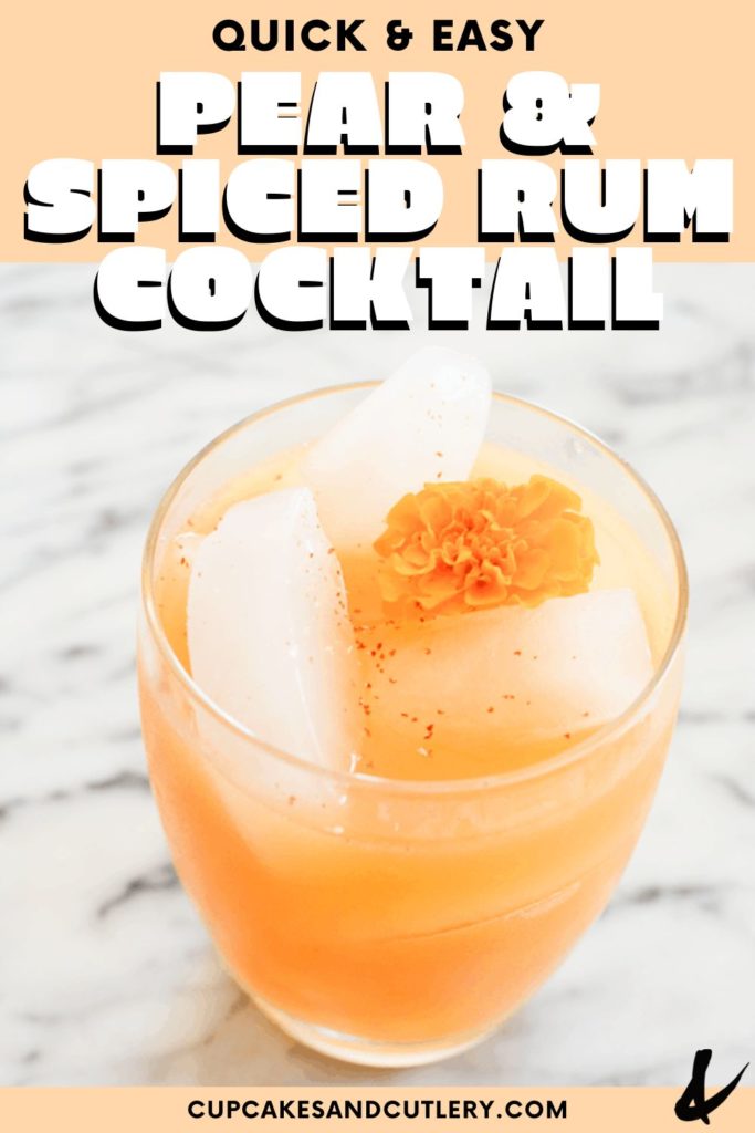 An orange cocktail in a short glass with a flower garnish and text that says "pear and spiced rum cocktail".