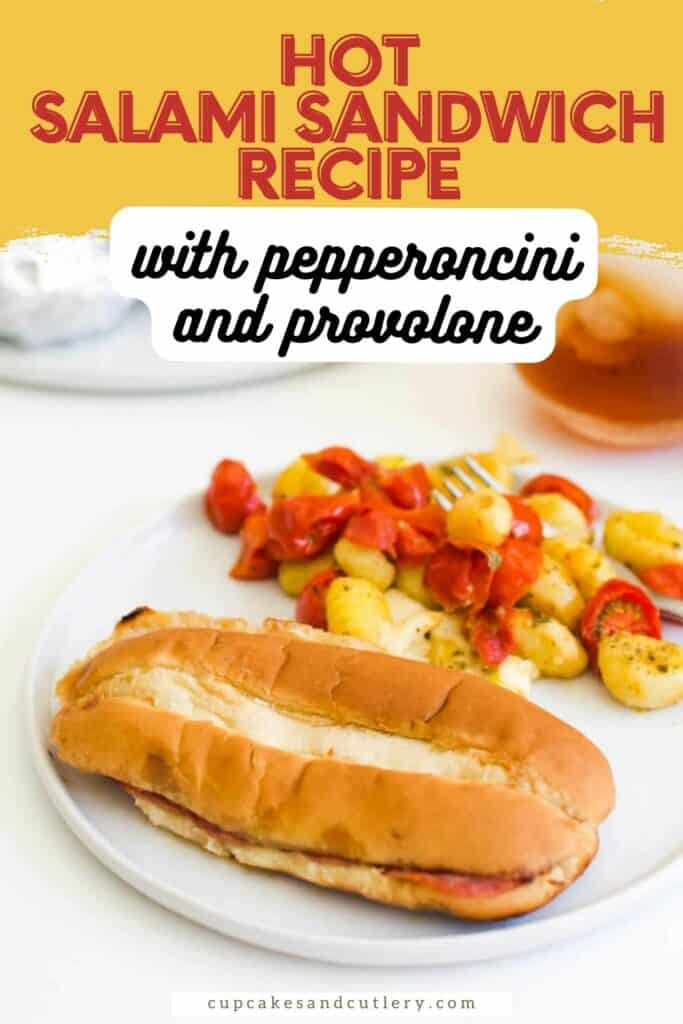 Text: Hot Salami Sandwich Recipe with Pepperoncini and provolone with a sandwich on a roll on a white plate next to a gnocchi salad.