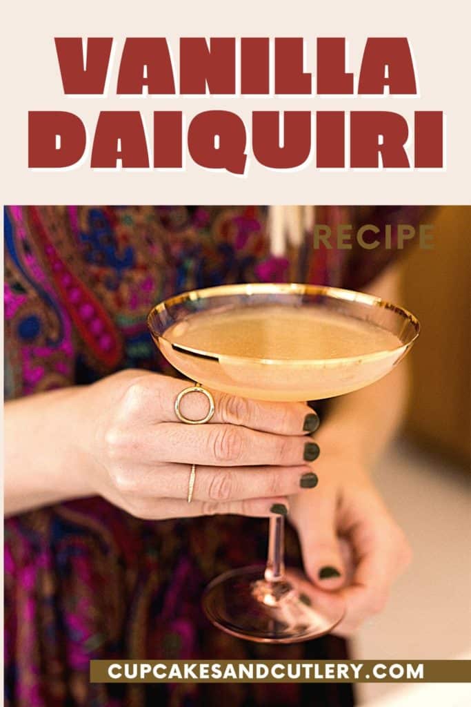 Woman holding a daiquiri made with spiced rum.