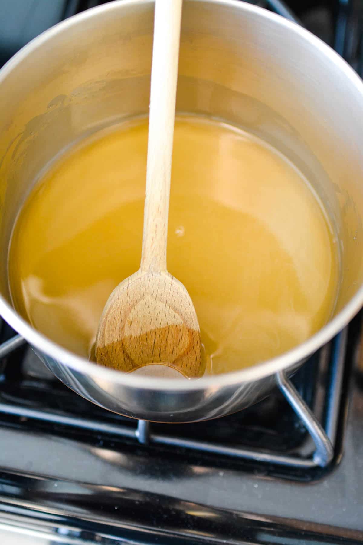 Vanilla simple syrup being made in a pan on the stove.