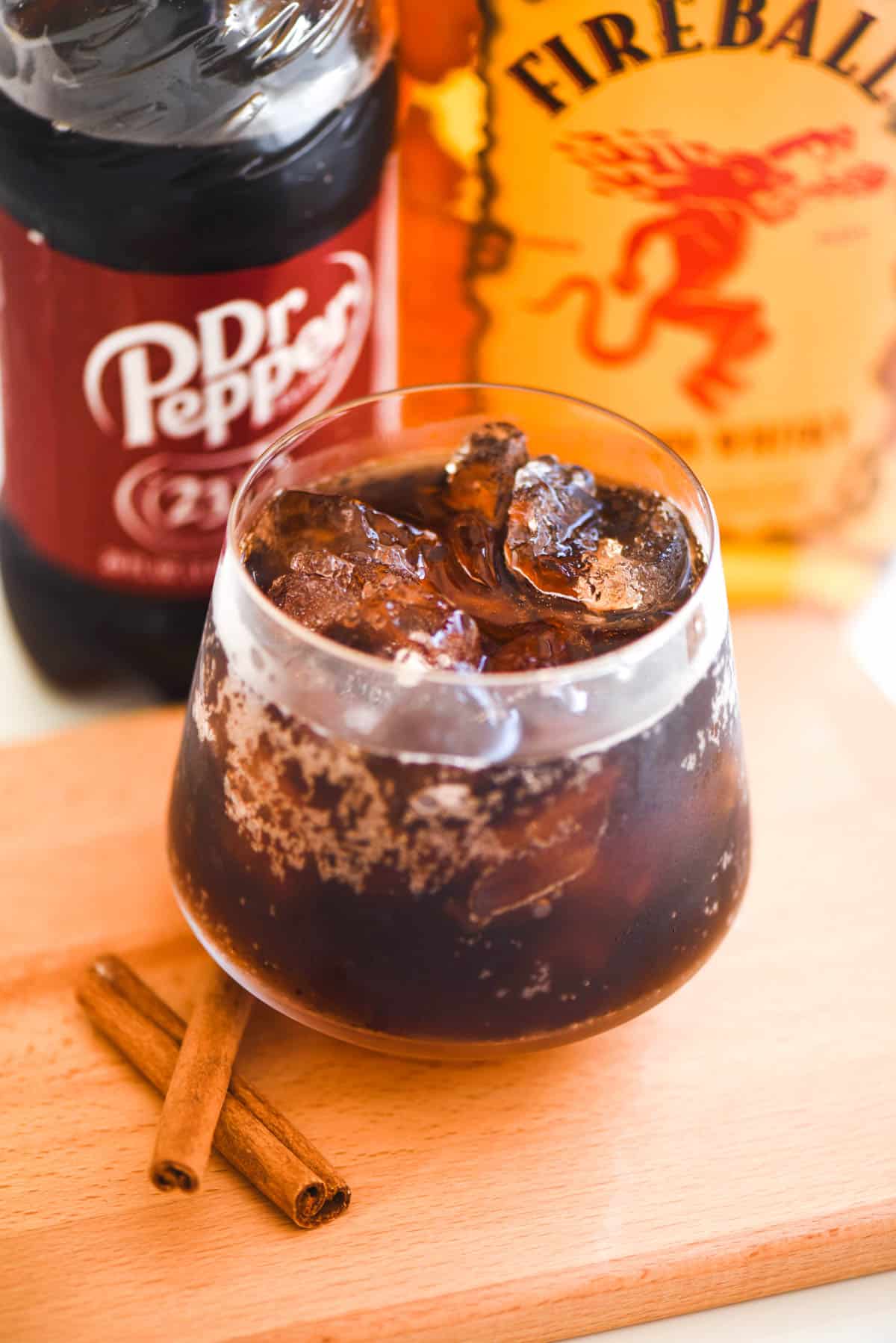 A Dr. Pepper cocktail in a glass on a counter.