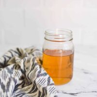 Close up of vanilla simple syrup in a glass jar.