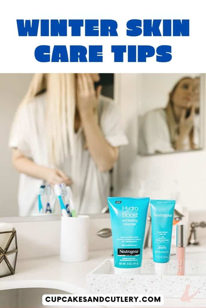 Skin care products on a counter in the bathroom with a woman in the background putting them on her face.