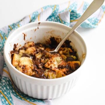 Close up of microwave bread pudding for one in a small bowl.
