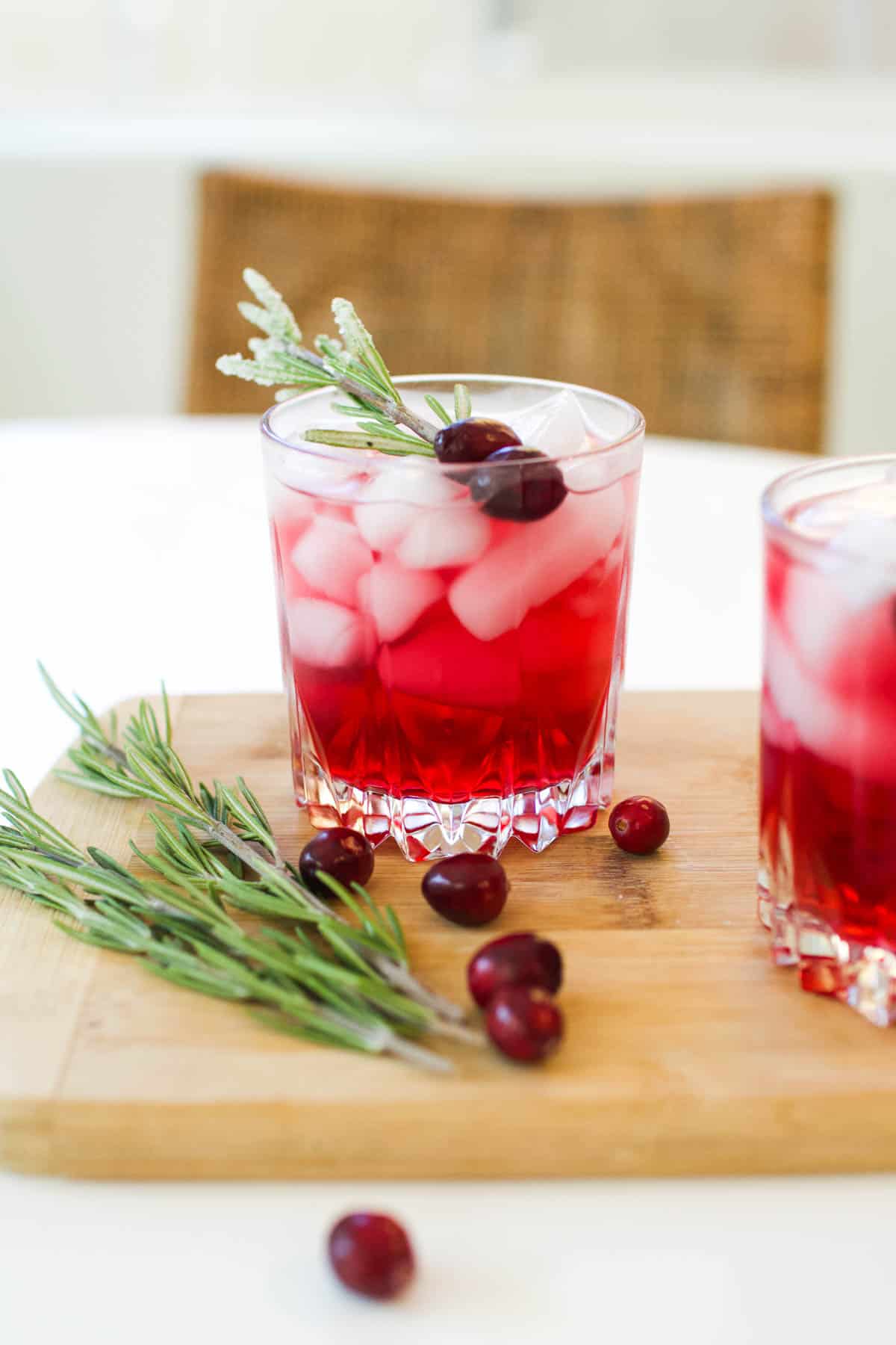 Vodka and Cranberry in a cocktail glass with rosemary garnish.