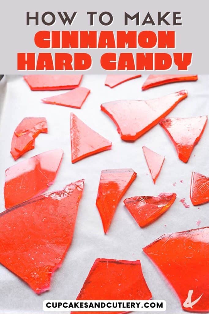 Red cinnamon hard candy broken up on a piece of wax paper.