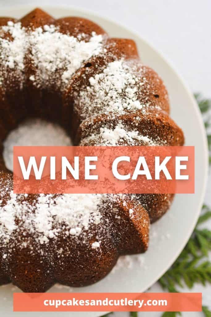 Top down view of a white wine cake on a white plate and topped with powdered sugar.