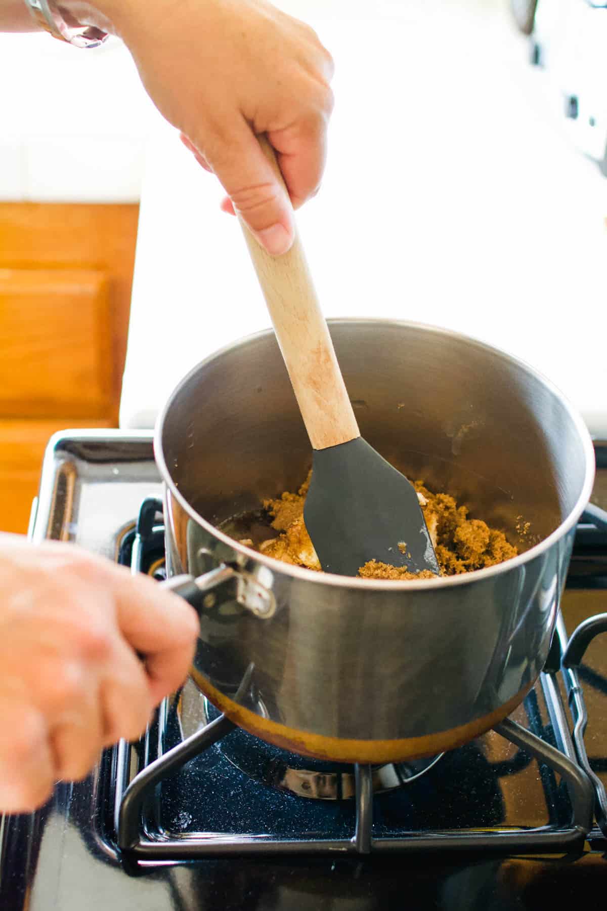 Woman mixing a saucepan on the stove.