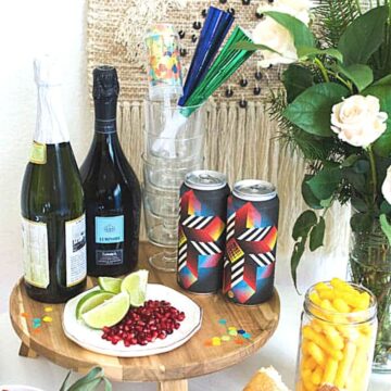 Close up of a beverage station set up on a table for a casual but fancy New Year's Eve at home.