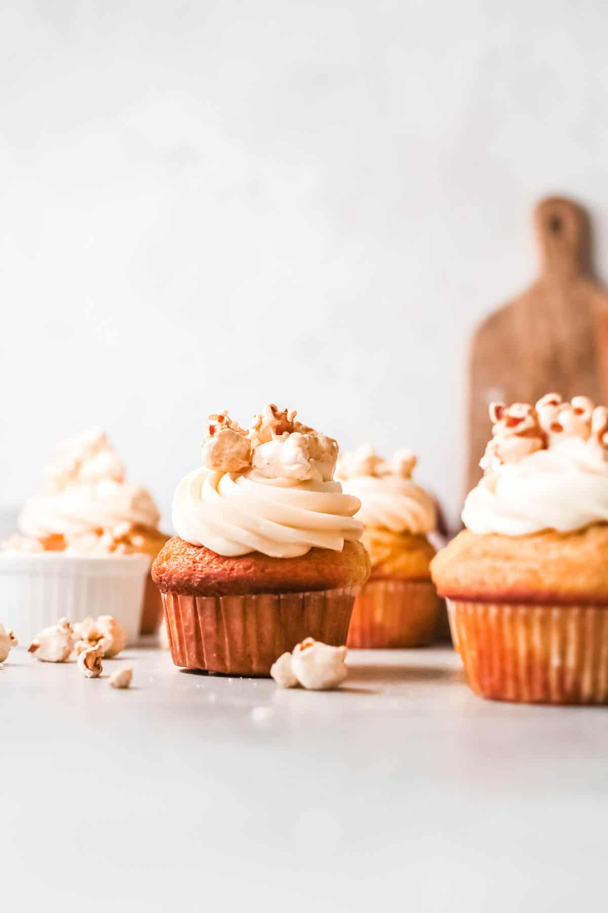 Caramel Popcorn Cupcakes on a table.